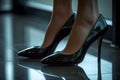 Chic and elegant modern women flaunts a black patent stiletto