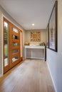 Chic foyer with a glass panel front door and white console table