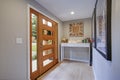 Chic foyer with a glass panel front door and white console table