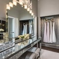 A chic and glamorous dressing room with a mirrored vanity table, a chandelier, and a walk-in closet4, Generative AI