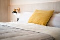 Chic and luxury yellow pillow and white blanket on white oak wooden single bed with bedside hanging lamp in cozy bedroomÃ Â¹Æ Royalty Free Stock Photo