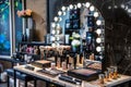 A chic makeup studio with a large mirror bright lights and an array of cosmetic products on a stylish table creating an