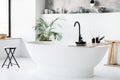 Chic, minimalist bathroom with modern striking freestanding tub, interior shot Royalty Free Stock Photo