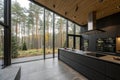 Chic modern kitchen with panoramic forest view Royalty Free Stock Photo