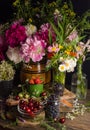 Chic summer still life with peonies and strawberries, cherries on a black background Royalty Free Stock Photo