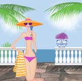 Chic Young Woman in a Bikini Holding a Drink Royalty Free Stock Photo