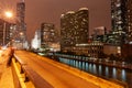 Chicago buildings, towering overhead, overground railway, urban roads, Columbus Drive Bridge and street lights streams with light