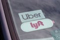 Uber and Lyft stickers displayed. Lyft and Uber ride sharing has replaced many Taxi cabs for transportation III