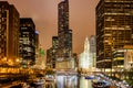 Chicago city illuminated buildings in the evening. Reflections on the river canal Royalty Free Stock Photo