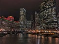 Chicago cityscape illuminated with Christmas holiday decorations and city night lights reflecting on the river.