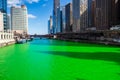 Chicago cityscape and tour boats around a vibrant dyed-green Chicago River