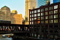 Chicago downtown during evening commute as an El train passes over Chicago River. Royalty Free Stock Photo