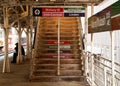 Commuter sits on a bench at Chicago's elevated el train platform near a set of stairs at the Adams/Wabash stop in Chicago Royalty Free Stock Photo