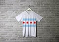 Chicago flag on shirt and hanging on the wall with brick pattern wallpaper Royalty Free Stock Photo