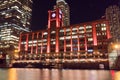 Night time exterior establishing shot of red clock tower Royalty Free Stock Photo