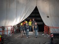 Chicago, IL - March 10th, 2020: Construction workers pass through the tented and tarped facade of the Tribune Tower in downtown as Royalty Free Stock Photo