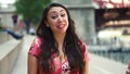 Young Latina woman at Chicago River Walk is having an exciting conversation