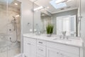 A modern white bathroom with a tiled shower