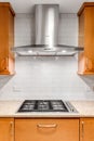 Detail shot of a Bosch hood and stove top in a modern kitchen.