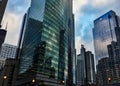 Chicago cityscape reflects on surfaces of mirrored windows as Willis Tower stands guard.