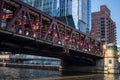 Colorful morning in Chicago Loop with view of Lake St bridge where commuters cross in shadows created by summer morning light