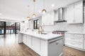 A modern luxurious kitchen with white and black cabinets.