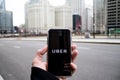 Chicago,IL,USA,Feb-21,2017,Man holding a smartphone with open Uber app in the city for editorial use only Royalty Free Stock Photo