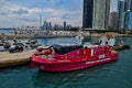 Chicago Fire Department rescue boat docked on Lake Michigan in Chicago, with skyline and boat harbor in background.