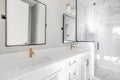 A modern, luxury white bathroom with the lights off. Royalty Free Stock Photo