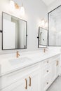 A modern, luxury white bathroom with gold hardware. Royalty Free Stock Photo