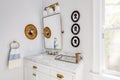 A small white bathroom with gold features. Royalty Free Stock Photo