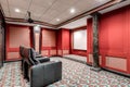 Home theater with red walls and recliners