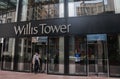 Willis Tower entrance in downtown Chicago, Illinois with a well-dressed older man leaving the building