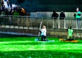 Kayakers paddle along the Chicago River, which is dyed green for St. Patrick`s day, as crowds surround scene.