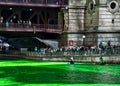 Kayakers paddle along the Chicago River, which is dyed green for St. Patrick`s day, gathering attention