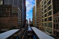 Chicago pink line elevated `el` train entering station located at the Adams Street and Wabash Avenue station in the downtown area