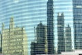 Buildings reflected in the glass wall of another building. Chicago, IL, USA. September 16, 2016. Royalty Free Stock Photo