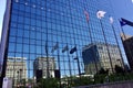 Flags and buildings reflected in a modern glass building. Chicago, IL, USA. September 20, 2016. Royalty Free Stock Photo