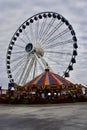 The Navy Pier Ferris Wheel and Carousel under a cloudy sky. Chicago, IL, USA. September 22, 2016.