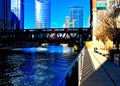 Shadows of fence are cast on riverwalk alongside the Chicago River on a morning in the downtown Loop.