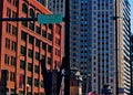 Statue of man on tightrope on Kinzie Street in Chicago, with pedestrian walk sign.