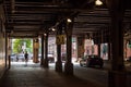 Woman and man commuter separate from crowd & entering creepy dark underpass in Chicago Loop