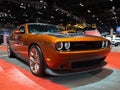 Front view of an orange Dodge Challenger displayed at the Chicago Auto Show