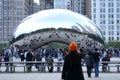 Chicago, Illinois, U.S - October 13, 2018 - A lady taking a picture of Cloud Gate, also known as `The Bean`, a popular tourist s