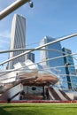 Jay Pritzker Pavillion designed by architect Frank Gehry and downtown city skyline Royalty Free Stock Photo