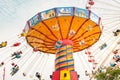 The rotating chair swing ride carousel with people in the Navy Pier park