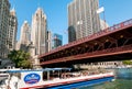 Sightseeing cruise with tourists on Chicago River under the DuSable Bridge towards Lake Michigan, Illinois, USA Royalty Free Stock Photo
