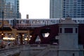 Sunset over Chicago Loop as el train passes over Wells and Wacker during rush hour commute Royalty Free Stock Photo