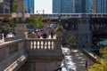 Chicago Loop scene of business and pleasure, from commuters to recreation seekers on upper Wakcer Dr and the lower riverwalk