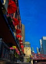 Chicago, low angle view, looking upwards towards colorful umbrellas, flower pots and other cityscape.